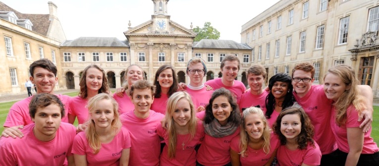 A group of students in pink t-shirts, gathered in Front Court and all smiling at the camera.